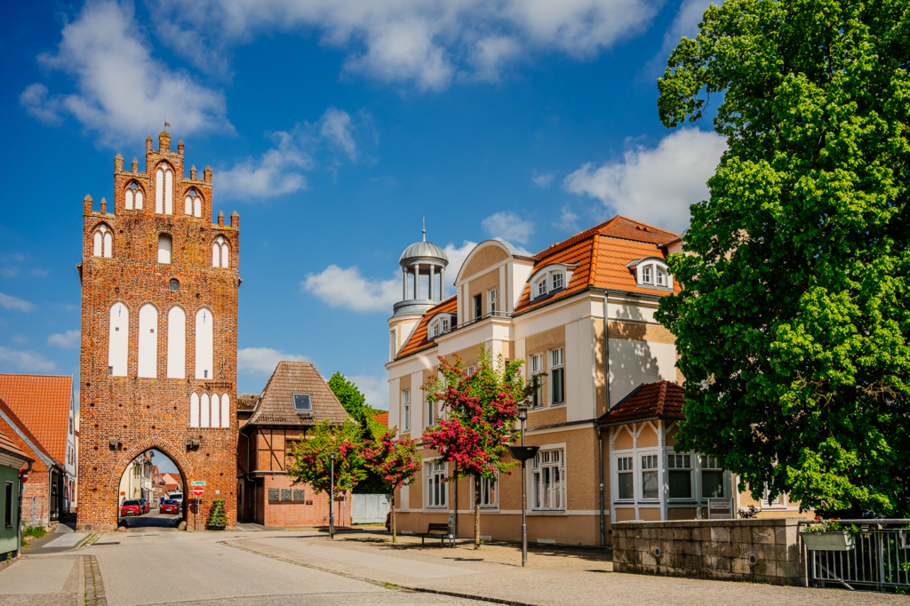 Mühlentor in Grimmen mit spätgotischem Backsteinturm an der historischen Stadtzufahrt unter blauem Frühlingshimmel